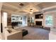 Open-concept living room featuring a fireplace, coffered ceilings, and seamless access to the kitchen at 632 Creekside Trce, Covington, GA 30014