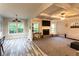 Spacious living room with a fireplace, large windows, coffered ceilings and a connecting kitchen at 632 Creekside Trce, Covington, GA 30014
