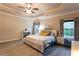 Large bedroom with trey ceilings, ceiling fan, and decorative wall art at 632 Creekside Trce, Covington, GA 30014