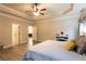 Main bedroom with tray ceiling and views into dining and bathroom at 632 Creekside Trce, Covington, GA 30014