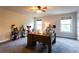Home office with two windows, neutral paint, ceiling fan, and carpet flooring at 632 Creekside Trce, Covington, GA 30014