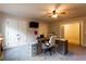 Nicely appointed office with desk, two windows, storage, and carpet flooring at 632 Creekside Trce, Covington, GA 30014