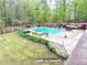 A top-down view of a home pool area with lounge chairs and wooded surroundings at 632 Creekside Trce, Covington, GA 30014