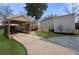 Backyard featuring a covered parking area, stone patio, and manicured lawn at 1320 Hosea L Williams Ne Dr, Atlanta, GA 30317
