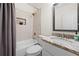 Bathroom featuring a shower over the tub, a large mirror and vanity with granite countertop at 1320 Hosea L Williams Ne Dr, Atlanta, GA 30317