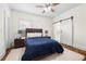Cozy bedroom with hardwood floors, ceiling fan and barn door access to en-suite bathroom at 1320 Hosea L Williams Ne Dr, Atlanta, GA 30317