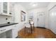Bright dining area featuring hardwood floors, modern lighting, and an adjacent pantry at 1320 Hosea L Williams Ne Dr, Atlanta, GA 30317