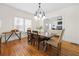 Elegant dining room with a rustic table, chandelier, and hardwood floors at 1320 Hosea L Williams Ne Dr, Atlanta, GA 30317
