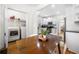 Well-lit kitchen with stainless steel appliances, wood table and a laundry room at 1320 Hosea L Williams Ne Dr, Atlanta, GA 30317
