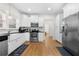 Bright kitchen featuring white cabinets, stainless steel appliances, and hardwood floors at 1320 Hosea L Williams Ne Dr, Atlanta, GA 30317