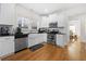 Modern kitchen with white cabinets, stainless steel appliances, and black countertops at 1320 Hosea L Williams Ne Dr, Atlanta, GA 30317