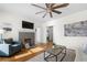 Comfortable living room with hardwood floors, a ceiling fan, and a decorative fireplace at 1320 Hosea L Williams Ne Dr, Atlanta, GA 30317