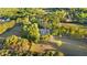 Aerial view featuring a well-manicured lawn, mature trees, a circular driveway and a beautiful home at 576 Tope Rd, Sharpsburg, GA 30277