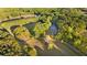 Ariel view of a beautiful home surrounded by mature trees, lush greenery, a private pond, and manicured lawns at 576 Tope Rd, Sharpsburg, GA 30277