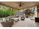 Comfortable back porch with lounge seating and wood ceiling overlooking the private yard at 576 Tope Rd, Sharpsburg, GA 30277