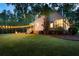 Backyard features an expansive lawn, string lights, a firepit, and plenty of room for outdoor activities at 576 Tope Rd, Sharpsburg, GA 30277