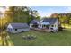 Aerial view of a property with a large backyard, a fire pit, a shed, covered porch and lush green lawn at 576 Tope Rd, Sharpsburg, GA 30277
