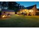 Backyard has a firepit with chairs, a large lawn, and a covered deck area for outdoor entertaining at 576 Tope Rd, Sharpsburg, GA 30277