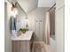 Bathroom featuring double sinks, wood cabinetry, modern fixtures, and decor at 576 Tope Rd, Sharpsburg, GA 30277