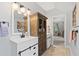 Bathroom with white vanity, wood cabinet, modern fixtures, and decor at 576 Tope Rd, Sharpsburg, GA 30277