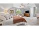Spacious bedroom featuring sitting area, ceiling fan and large window with decorative curtains at 576 Tope Rd, Sharpsburg, GA 30277