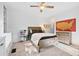 Bedroom with wooden bed frame, built-in shelving, ceiling fan and light color palette at 576 Tope Rd, Sharpsburg, GA 30277