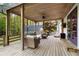 Covered outdoor living space with ceiling fan and wooden decor with seating at 576 Tope Rd, Sharpsburg, GA 30277
