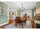 Charming dining room with wood table, chandelier, and access to other rooms at 576 Tope Rd, Sharpsburg, GA 30277