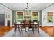 Traditional dining room with wood floors, green walls, and windows with natural light at 576 Tope Rd, Sharpsburg, GA 30277