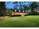 Charming home with a covered front porch, manicured lawn, and beautiful landscaping at 576 Tope Rd, Sharpsburg, GA 30277