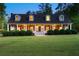 Charming home features a welcoming porch, dormer windows, and manicured landscaping at 576 Tope Rd, Sharpsburg, GA 30277