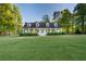 Charming single-Gathering home featuring a manicured front lawn, dormer windows and a large porch at 576 Tope Rd, Sharpsburg, GA 30277
