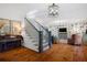 Elegant foyer with hardwood floors, staircase, piano, and stylish decor at 576 Tope Rd, Sharpsburg, GA 30277