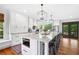 Modern kitchen with island seating, stainless steel appliances, and hardwood floors at 576 Tope Rd, Sharpsburg, GA 30277