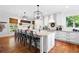 Modern kitchen features a large center island with bar stool seating and wood floors at 576 Tope Rd, Sharpsburg, GA 30277