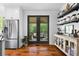 Modern kitchen featuring stainless steel appliances, open shelving, and access to the patio at 576 Tope Rd, Sharpsburg, GA 30277