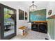 Bright laundry room featuring modern washer and dryer, stylish tiling, and convenient bench seating at 576 Tope Rd, Sharpsburg, GA 30277