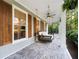 Inviting porch with brick floors and a swing; perfect for relaxing outdoors at 576 Tope Rd, Sharpsburg, GA 30277