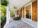 Cozy brick porch with swing, offering a relaxing spot with a view of the wooded area at 576 Tope Rd, Sharpsburg, GA 30277