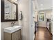 Compact powder room with a modern sink, stylish mirror, and easy access to the kitchen area at 738 Saint Charles Ne Ave, Atlanta, GA 30306