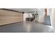 Spacious garage featuring a gray floor, utilities, and convenient access stairs at 738 Saint Charles Ne Ave, Atlanta, GA 30306