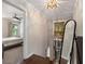 Bright hallway with an elegant chandelier and a bedroom view, enhancing the home's charm at 738 Saint Charles Ne Ave, Atlanta, GA 30306