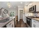Modern kitchen with stainless steel appliances, a decorative backsplash, and views of the powder room at 738 Saint Charles Ne Ave, Atlanta, GA 30306