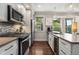 Modern kitchen with stainless steel appliances, a decorative backsplash, and an integrated wine cooler at 738 Saint Charles Ne Ave, Atlanta, GA 30306