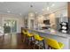 Well-lit kitchen with a breakfast bar, stainless steel appliances, pendant lighting, and yellow bar stools at 738 Saint Charles Ne Ave, Atlanta, GA 30306