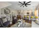 Open-concept living room featuring modern furnishings, a stylish kitchen, and a unique decorative clock at 738 Saint Charles Ne Ave, Atlanta, GA 30306