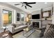 Cozy living room with a fireplace, large windows, and contemporary decor at 738 Saint Charles Ne Ave, Atlanta, GA 30306
