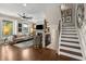 Hardwood floored living space features staircase and a fireplace at 738 Saint Charles Ne Ave, Atlanta, GA 30306