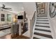 Cozy living room adjacent to a staircase with dark wood treads, complemented by decorative wall art at 738 Saint Charles Ne Ave, Atlanta, GA 30306