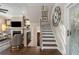 Inviting living room with a staircase featuring dark wood treads and a decorative wall clock at 738 Saint Charles Ne Ave, Atlanta, GA 30306